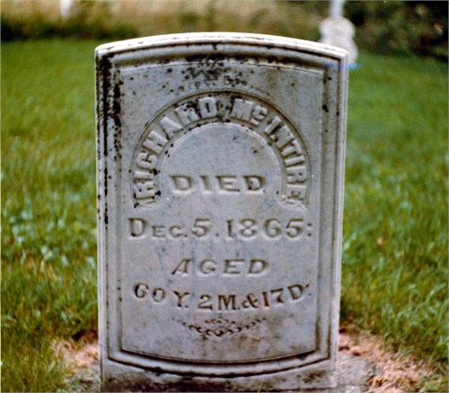 Weathered cemetery gravestone with the inscription 'DIED Dec. 5, 1865' and the word 'AGED' visible beside it.